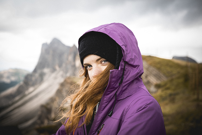 Ginger girl portrait in front of mountain, Tirol, Trentino-South Tyrol, Italy