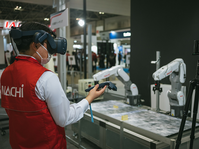 Tokyo, International Robot Exhibition 2022 A staff from Japan   leading manufacturer Nachi uses VR devices to control a robotic arm during the International Robot Exhibition 2022 on March 10, 2022 in Tokyo, Japan. March 10, 2022  Photo by Nicolas Datiche AFLO   JAPAN 