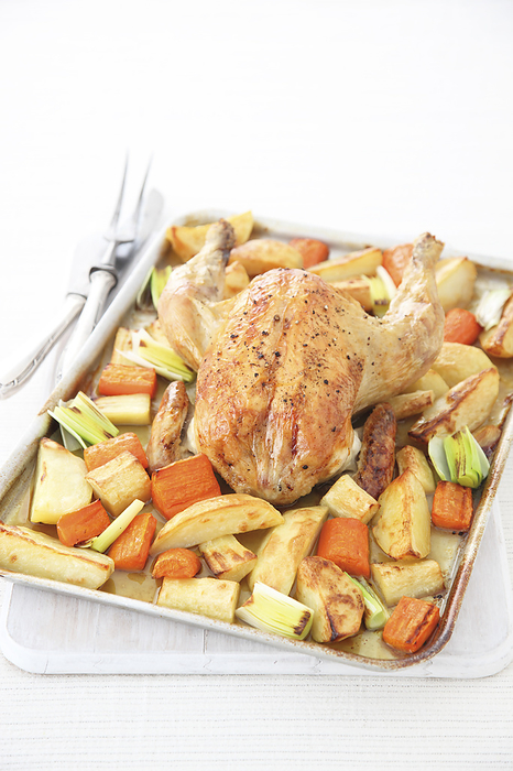 Tray of roast chicken, potatoes, parsnip and carrot Tray of roast chicken, potatoes, parsnip and carrot., Photo by DK IMAGES SCIENCE PHOTO LIBRARY