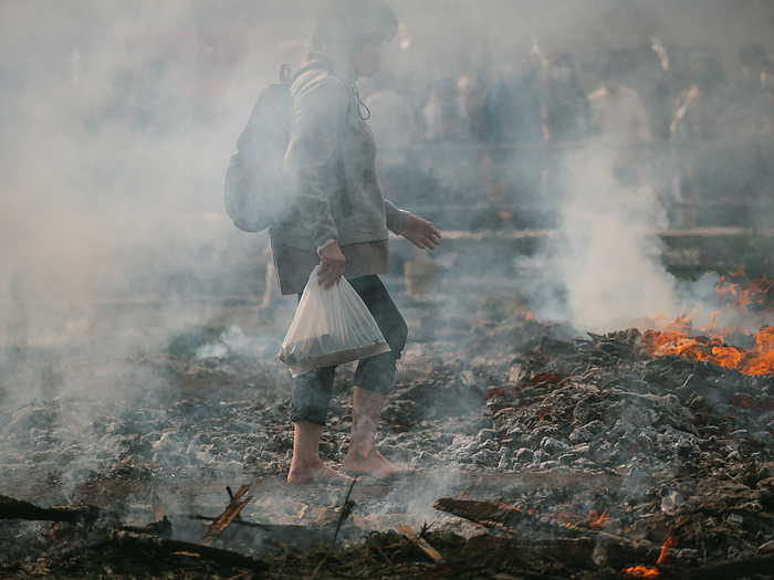 Tokyo, Hiwatari matsuri fire walking festival A worshiper walks over smoldering coals with barefoot at the fire walking festival, called Hiwatari Matsuri in Japanese, at Mt.Takao in Tokyo, Japan, March 13, 2022. About 1,500 Japanese worshipers walk barefoot with Yamabushi and Buddhist monks over coals at the annual festival praying for the safety of themselves. March 13, 2022  Photo by Nicolas Datiche AFLO   JAPAN 