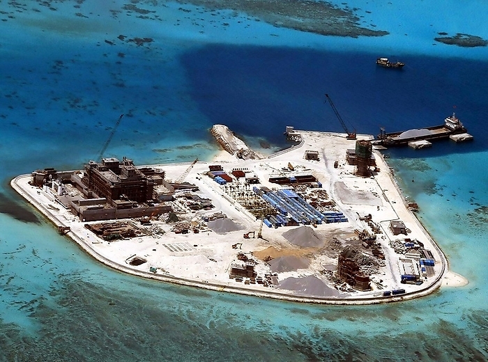 China   Philippines: An aerial view of Chinese development on Johnson South Reef in the disputed Spratly Islands, currently controlled by China and claimed by the Philippines as part of Palawan, c. 2015 China   Philippines: An aerial view of Chinese development on Johnson South Reef in the disputed Spratly Islands, currently controlled by China and claimed by the Philippines as part of Palawan, c. 2015  The Spratly Islands are a group of more than 750 reefs, islets, atolls, cays and islands in the South China Sea. The archipelago lies off the coasts of the Philippines and Malaysia  Sabah , about one third of the way to southern Vietnam. They comprise less than four square kilometers of land area spread over more than 425,000 square kilometers of sea. The Spratlys are one of three archipelagos of the South China Sea which comprise more than 30,000 islands and reefs and which complicate governance and economics in that region of Southeast Asia. br   br    Such small and remote islands have little economic value in themselves, but are important in establishing international boundaries. There are no native islanders but there are rich fishing grounds and initial surveys indicate the islands may contain significant reserves of oil and natural gas. br   br    About 45 islands are occupied by relatively small numbers of military forces from Vietnam, the People s Republic of China, the Republic of China  Taiwan , Malaysia and the Philippines. Brunei has also claimed an Exclusive Economic Zone  EEZ  in the southeastern part of the Spratlys encompassing just one area of small islands above mean high water  on Louisa Reef. 