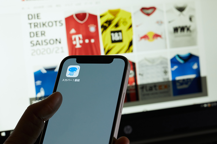 smartphone app The SKY PerfecTV  app is seen on a smartphone and the website of Bundesliga is displayed on a screen in Tokyo, Japan, February 16, 2022.  Photo by Shingo Tosha AFLO 
