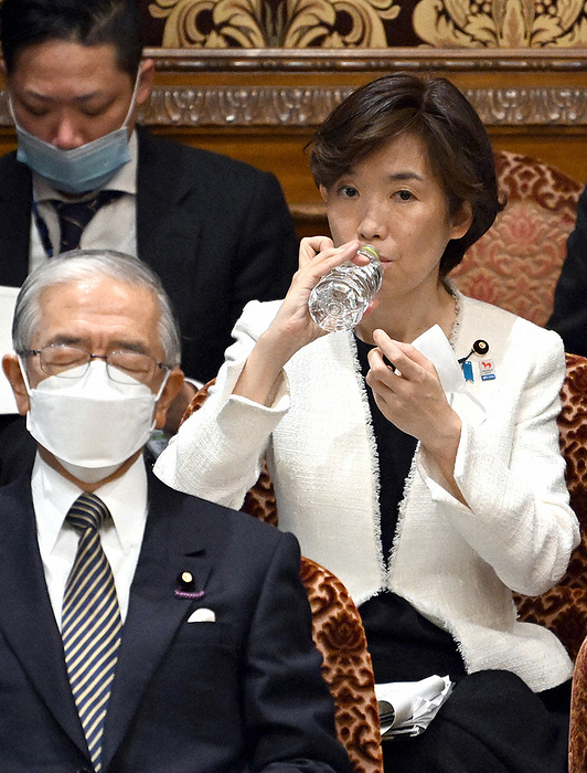 National Diet of Japan, House of Councillors, Committee on Accounts Minister in charge of vaccines, Akiko Horiuchi  right , sips a drink at a meeting of the upper house s accounts committee, in the Diet, March 28, 2022. 1:54 p.m., photo by Mikiharu Takeuchi