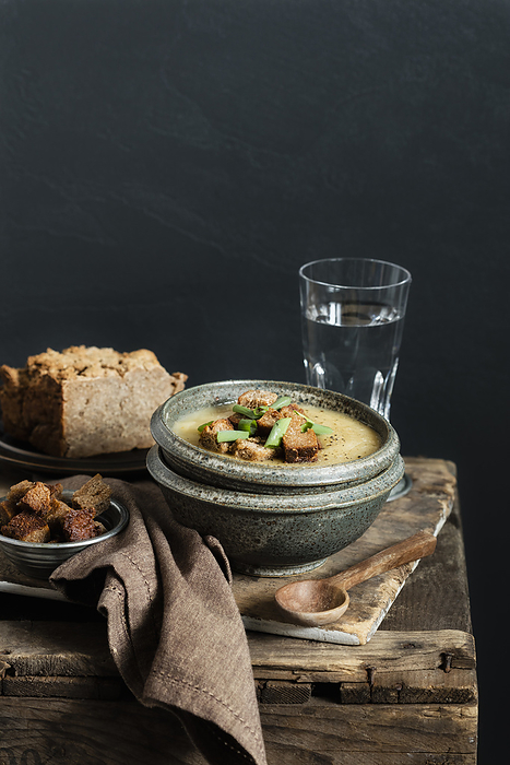 Jerusalem Artichoke soup garnished with croutons and scallions in bowl, Photo by Eva Gruendemann