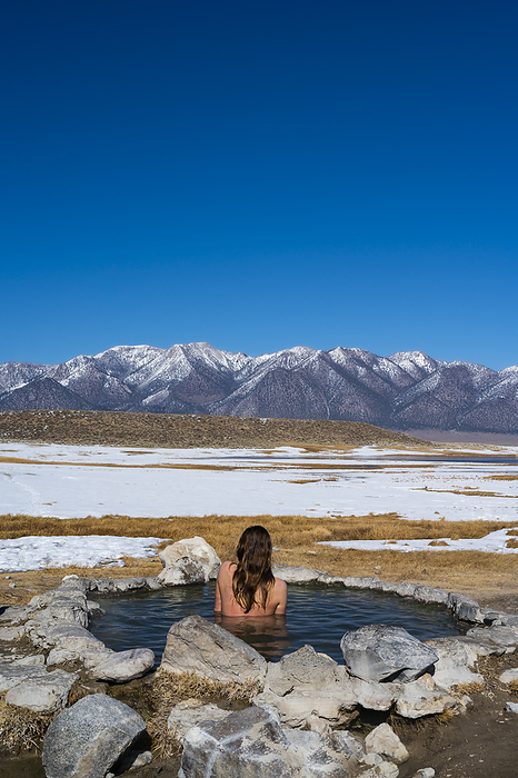 Female soaking in natural hot springs