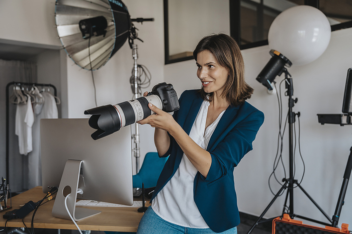 Photographer photographing through camera in studio