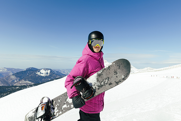 Man with snowboard on snowcapped mountain