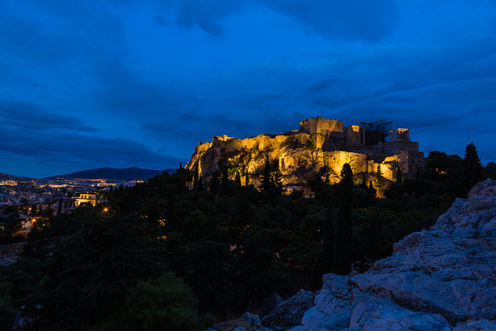 The Acropolis and Parthenon illuminated at night as seen from Areopagus Hill, Athens, Greece