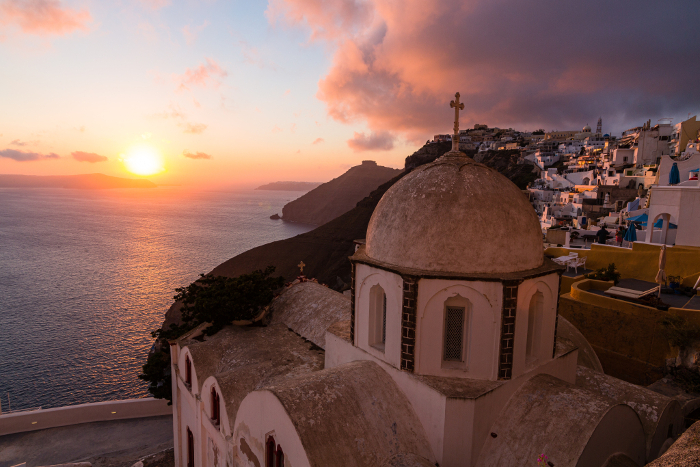 Sunset-tinted sky seen from the Church of St. Ioannis Theologos in Fira, Santorini, Greece.