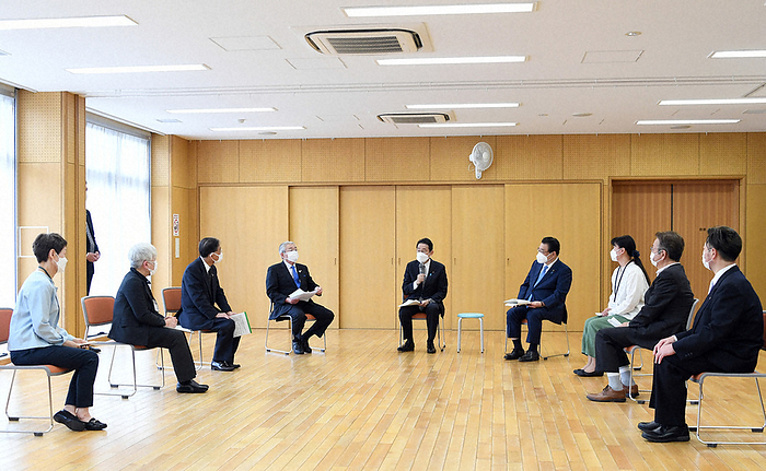 Prime Minister Fumio Kishida exchanging views in a round table discussion with a commissioner for civilian residents and children. Prime Minister Fumio Kishida  center  exchanges views in a round table discussion with a commissioned welfare and childcare worker. To his right is Minister of Health, Labor and Welfare Shigeyuki Goto at the ward Shinkawa Children s Center in Chuo ku, Tokyo, on the morning of May 12, 2022. 8:55 a.m.  representative photo 