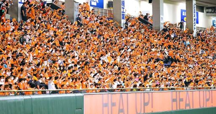 2022 Professional baseball Giants Chunichi. Giants fans in the right field bleachers get excited as the towel spinning cheering resumes. Photo taken at Tokyo Dome on May 13, 2022.