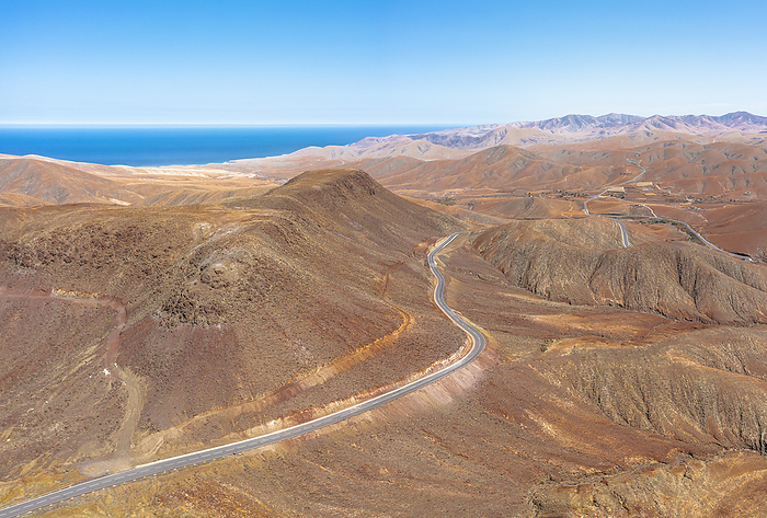 Winding road crossing the volcanic landscape towards Sicasumbre astronomical observatory, Fuerteventura, Canary Islands, Spain Winding road crossing the volcanic landscape towards Sicasumbre Astronomical Observatory, Fuerteventura, Canary Islands, Spain, Atlantic, Europe, Photo by Roberto Moiola