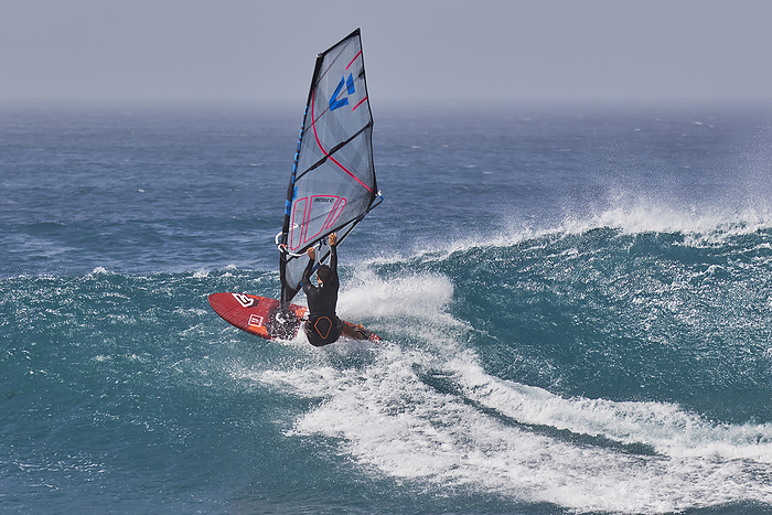 Wind surfing on Atlantic rollers at Ponta Preta, southwest coast of Sal, Cape Verde. Wind surfing on Atlantic rollers at Ponta Preta, southwest coast of Sal, Cape Verde Islands, Atlantic, Africa, Photo by Nigel Hicks