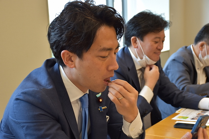 Shinjiro Koizumi, a member of the House of Representatives  foreground , takes a bite of a silkworm pupa. Shinjiro Koizumi, a member of the House of Representatives  foreground , tastes a silkworm pupa. Next to him on the right is Mr. Takebe Shin, Deputy Minister of Agriculture, Forestry, and Fisheries, who is promoting entomophagy at the First House of Representatives in Tokyo, May 2022. Photo by Sachi Machino, 4:09 p.m., May 20, 2022
