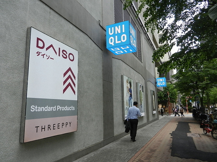 Daiso signage in subdued colors to match the city s atmosphere. The Daiso sign, now in a more subdued color scheme to match the atmosphere of the city. A UNIQLO store will be housed in the same building. Photo taken by Hiroko Michishita at 0:43 p.m. on April 7, 2022.