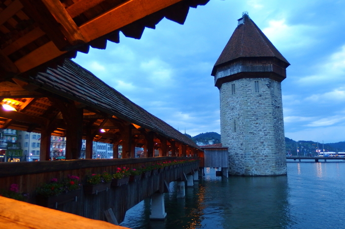 Kapell Bridge, a tourist attraction in Lucerne, Switzerland (river surface and tower from the bridge)