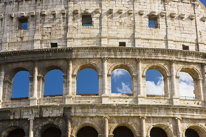 Detail of the exterior of the iconic Colosseum against a blue sky; Rome, Lazio, Italy, Photo by Bilderbuch / Design Pics