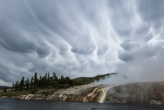 Mammatus clouds over the steamy cliffs and thermal runoff channels along the Firehole River at the Midway Geyser Basin in Yellowstone National Park; Wyoming, United States of America, Photo by Tom Murphy / Design Pics