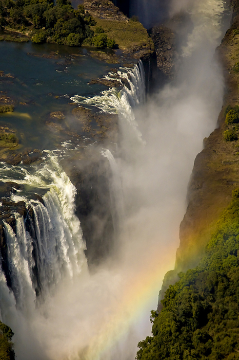 Aerial view of a rainbow over a waterfall., Photo by Ralph Lee Hopkins / Design Pics