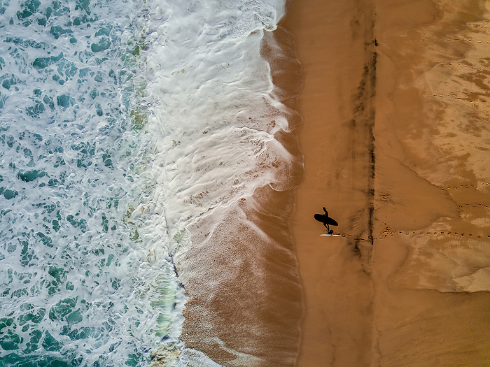 A surfer and his shadow as seen from the air., Photo by Ben Horton / Design Pics