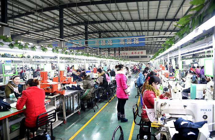 Bozhou, China Shoe factory On December 22, workers of Anta Xibao Footwear Co., Ltd. were producing and processing sports shoes in Qiao Cheng Economic Development Zone, Bozhou City, Anhui Province.