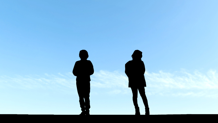 Silhouette of two awkward women figures_blue sky background