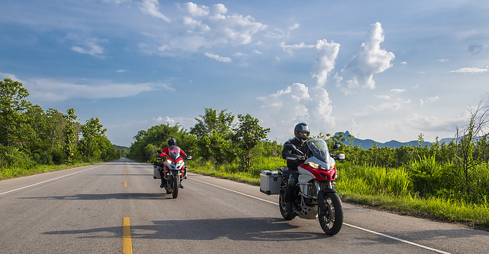 bikers riding on a straight road in northern Thailand