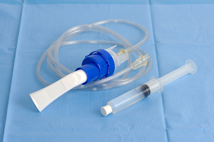 Inhalation therapy Inhalation therapy chamber and sterile saline syringe on blue sterile drape., by SHERRY YATES YOUNG SCIENCE PHOTO LIBRARY