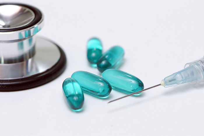 Blue gelatine pills Blue gelatine capsules, stethoscope, and syringe., by SHERRY YATES YOUNG SCIENCE PHOTO LIBRARY