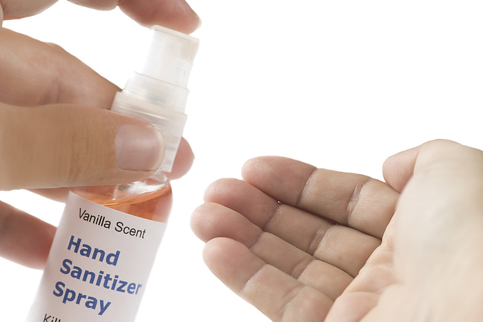 Spray hand sanitiser Spray hand sanitiser container. Applying alcohol based anti viral sanitiser to patient s hand., by SHERRY YATES YOUNG SCIENCE PHOTO LIBRARY