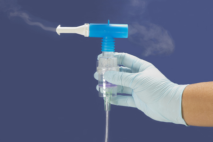 Albuterol mist Nurse holding mouthpiece of medical nebulizer for inhalation therapy with albuterol sulfate mist., by SHERRY YATES YOUNG SCIENCE PHOTO LIBRARY