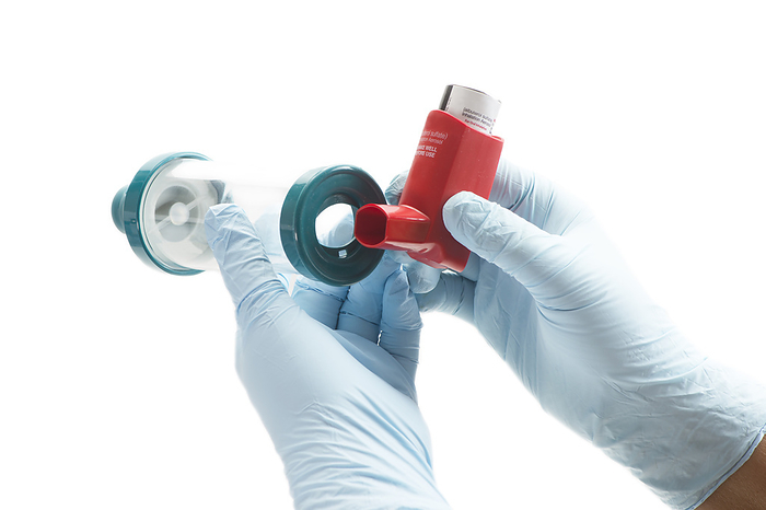 Spacer chamber Nurse attaching spacer chamber to asthma inhaler., by SHERRY YATES YOUNG SCIENCE PHOTO LIBRARY