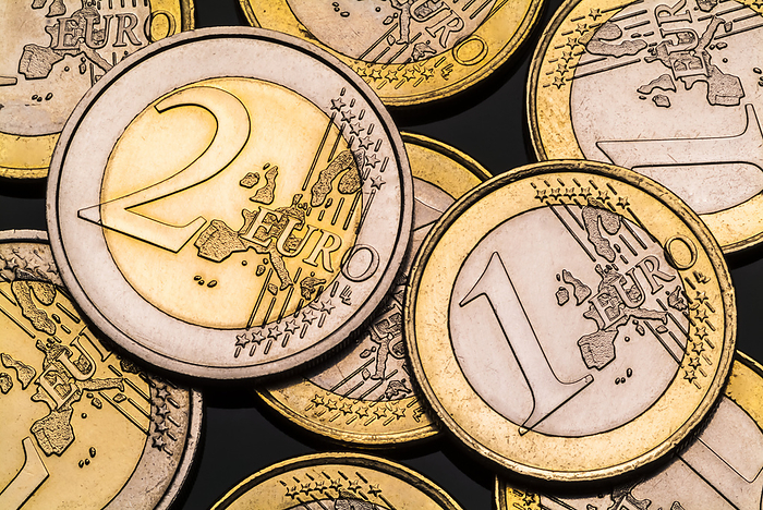 One and two Euro coins One and two Euro coins. The Euro became the currency of the Eurogroup of European Union countries in 1999. In 2020, 19 of the 27 EU member states, the Eurozone, use the euro currency. The 1 and 2 Euro coins are two toned, silver and gold. The 1 Euro coin has an outer part of nickel brass and the centre is layers of copper nickel, nickel and copper nickel. The 2 Euro coin has an outer part of copper nickel and the centre is layers of nickel brass, nickel and nickel brass. The copper alloys make the coinage antimicrobial. The common side on the 1 and 2 Euro coins show the landmass and all coins feature 12 stars in their design., by MARTYN F. CHILLMAID SCIENCE PHOTO LIBRARY