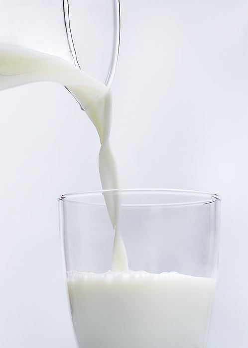 Milk Milk being poured from glass jug to tall glass