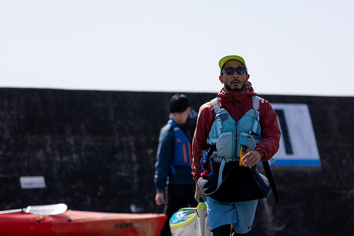 Japanese man working at a sea kayak store Kohei Maruo, a native of Minami Ise Town, Mie Prefecture and Kanagawa Prefecture, is working at Sunnyside Kayaks, a sea kayak store, as a Regional Development Cooperation Volunteer after traveling around the world.  Photo taken March 2022 