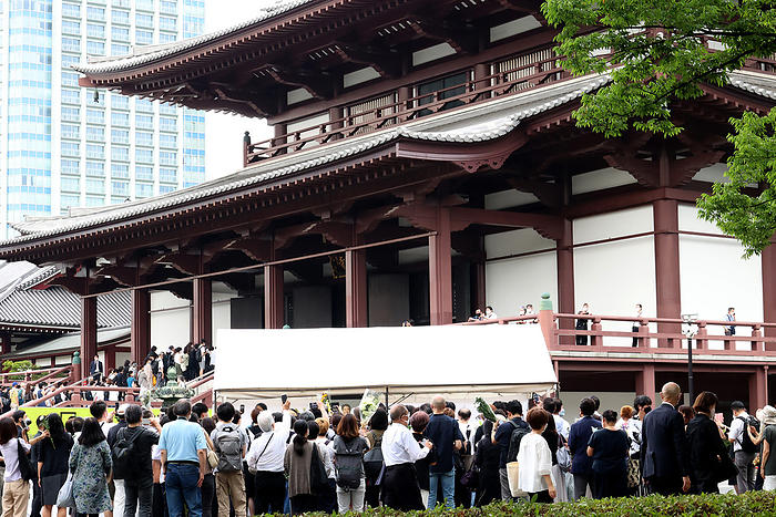 A hearse carrying body of former Prime Minister Shinzo Abe passes the prime minister s official residence after the funeral ceremony July 12, 2022, Tokyo, Japan   People make a long line to offer flower bouquets on an altar before starting the funeral ceremony of former Japanese Prime Minister Shinzo Abe at the Zojoji temple in Tokyo after the funeral ceremony while police officers bow their heads and salute on Tuesday, July 12, 2022. Abe was shot dead at a stamping tour in western Japan for the Upper House election on July 8.       Photo by Yoshio Tsunoda AFLO 