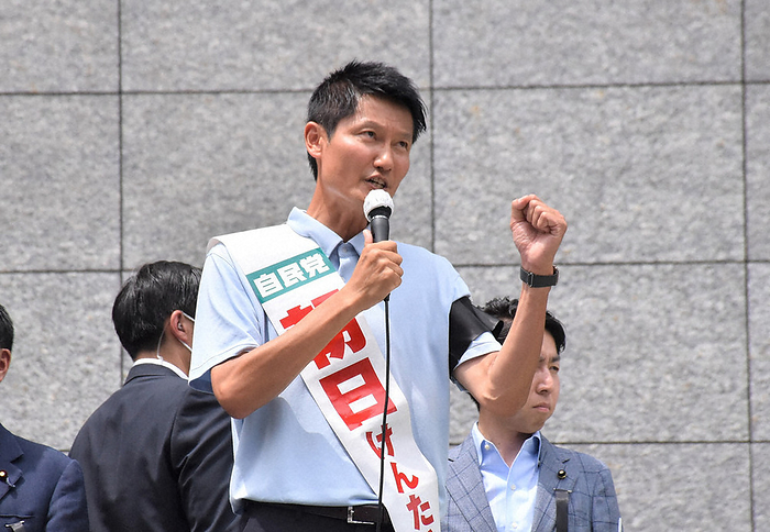 2022 House of Councillors election Kentaro Asahi, wearing a mourning badge on his arm, makes his final appeal amid tight security on the day after the death of former Prime Minister Shinzo Abe, in Tachikawa, July 9, 2022.