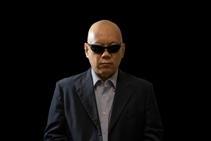 Strong-looking man wearing sunglasses.