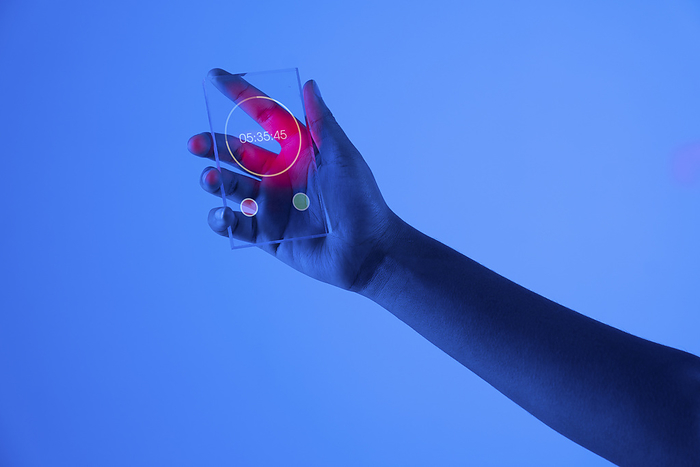   Hand of woman with stopwatch on futuristic transparent smart phone against blue background
