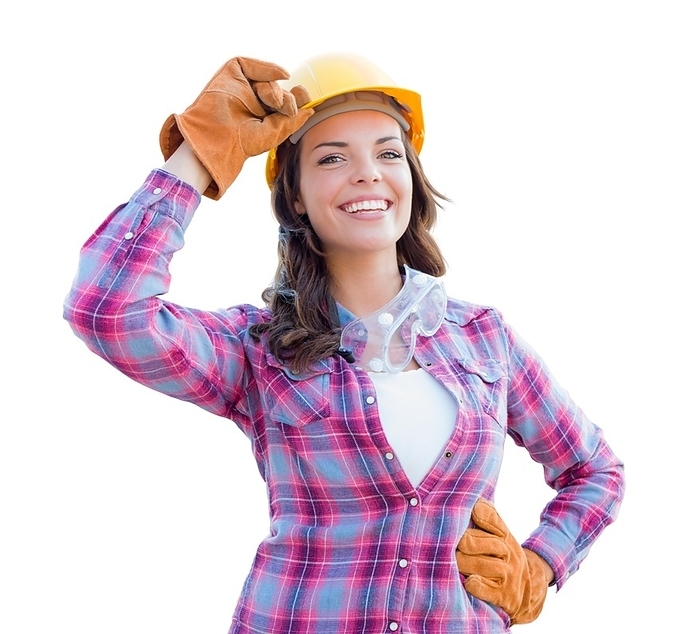 Young attractive female construction worker wearing gloves, hard hat and protective goggles isolated on white