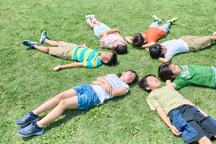 Japanese elementary school students relaxing on the lawn
