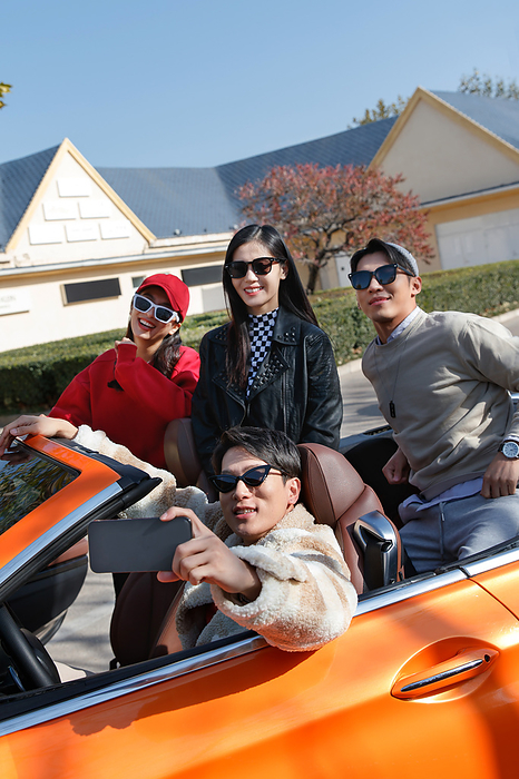 Young people use mobile phone take driving car to travel,china,Beijing