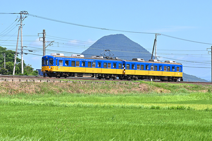 Kagawa Kotohira Electric Railway Type 1200 ordinary train in Ukrainian colors with Sanuki Fuji in the background Taken at Okada Station   Hama Station