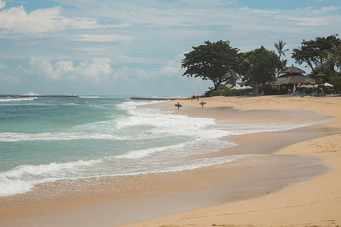 Surfers standing on the beach at the water's edge waiting for the waves at Geger Beach in the Nusa Dua resort area; Geger Beach, Badung, Bali, Indonesia, Photo by O'Neil Castro / Design Pics