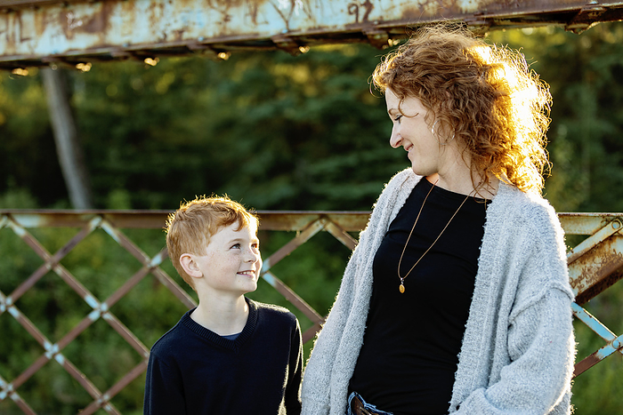 Mother and son looking at each other with smiles while at a park; Edmonton, Alberta, Canada, Photo by LJM Photo / Design Pics