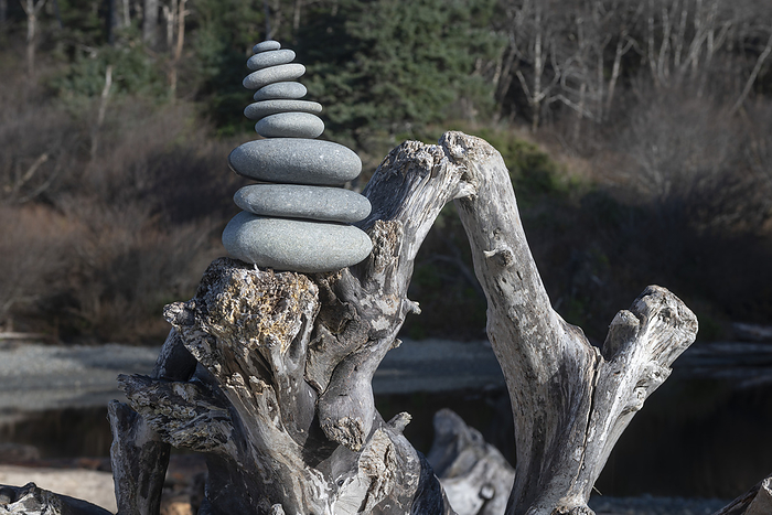 A cairn of rocks stacked on top of driftwood at Ruby Beach on the Olympic Peninsula in the Olympic National Park in  Washington State; Kalaloch, Washington, United States of America, Photo by Doug Ogden / Design Pics