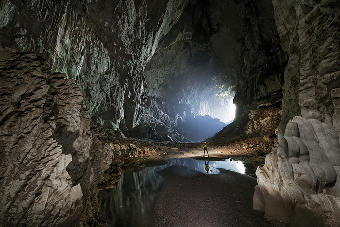 Researcher exploring stalagmites in a cave in Gunung Mulu National Park; Sarawak, Borneo, Malaysia, Photo by Robbie Shone / Design Pics