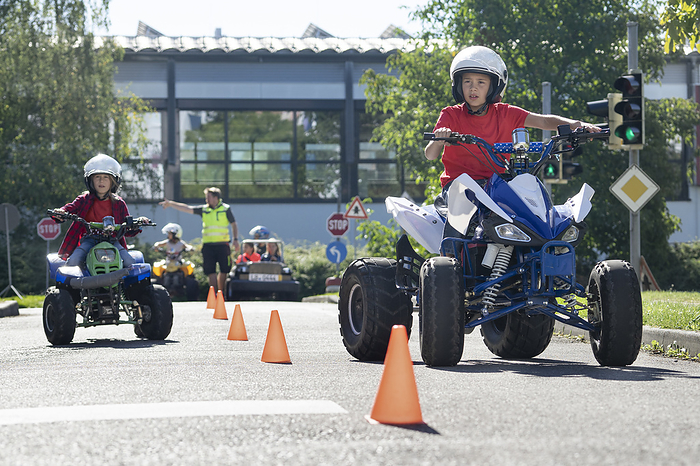 Kids driving a electric toy quads,traffic education for children,children on vehicles Boy riding quadbike on traffic course at traffic education training