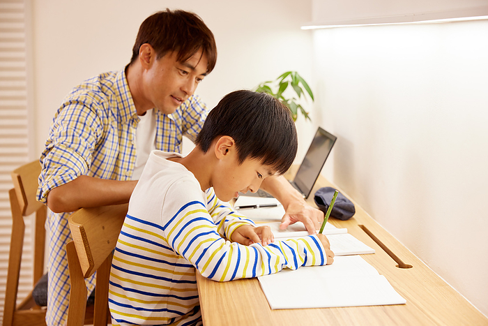 A Japanese father teleworking and his son studying