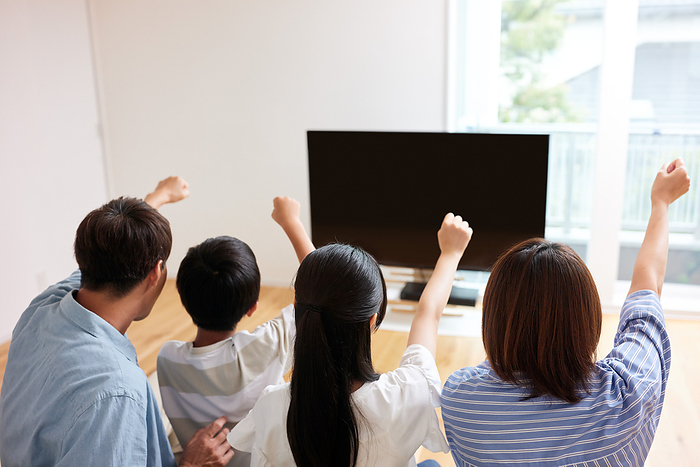 Japanese family cheering on TV